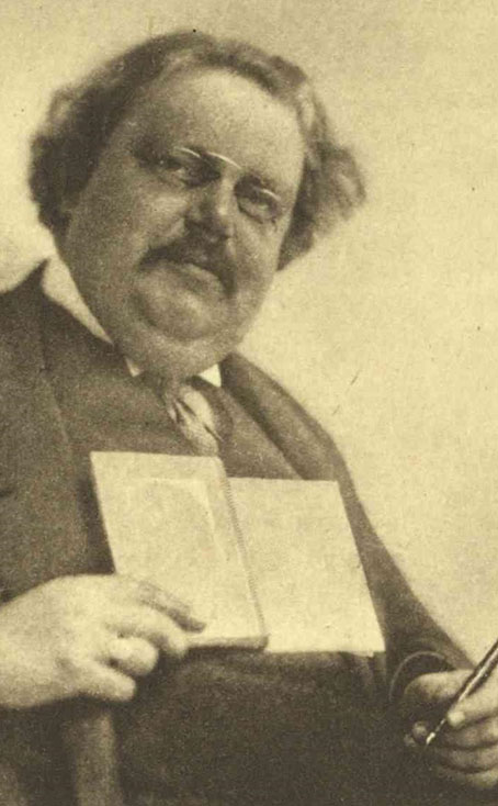G.K. Chesterton Holding a Book and Pen - Hartwell University