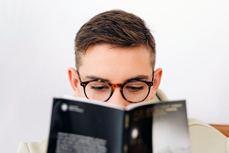 Guy with Glasses Reading